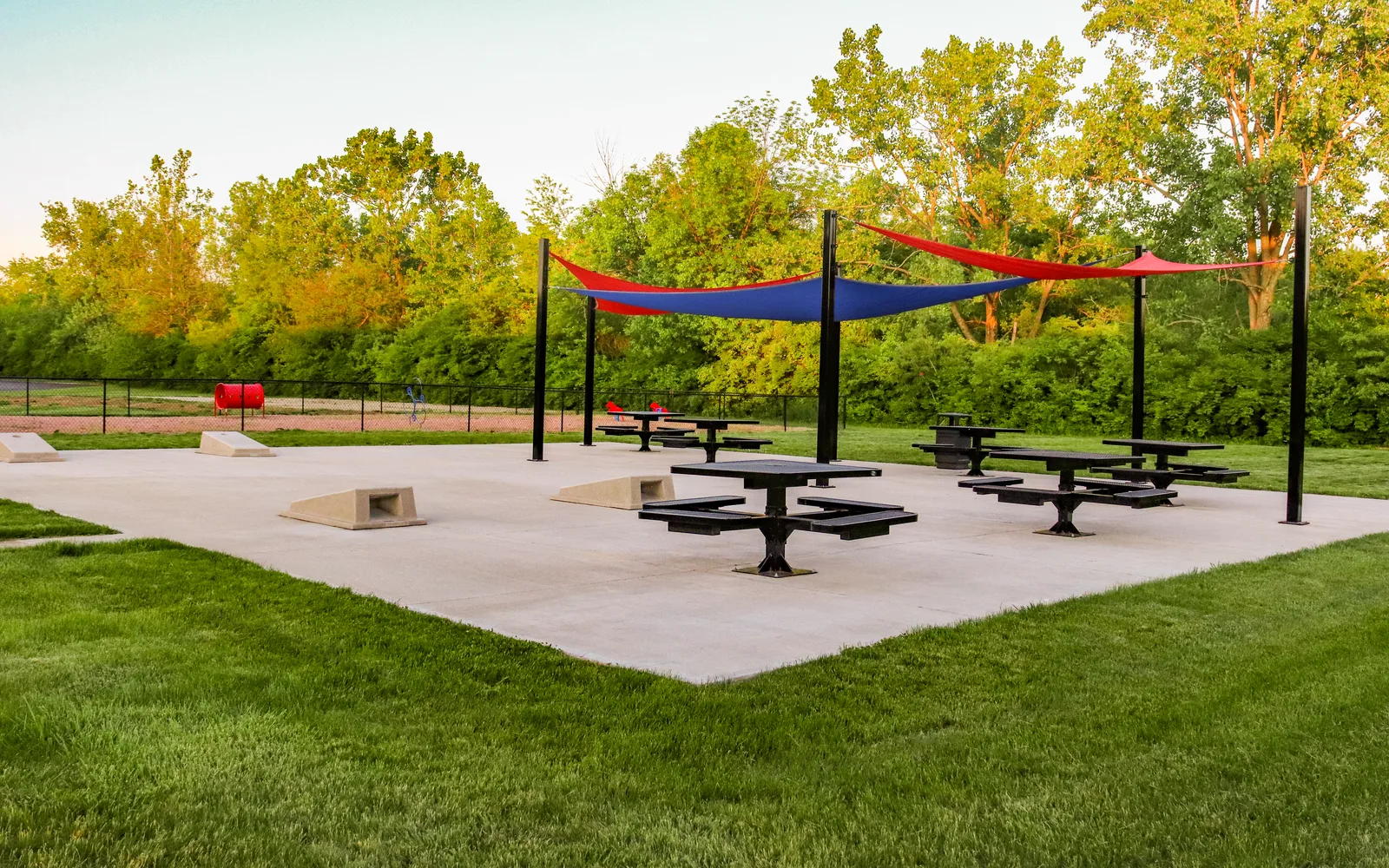 Residential apartment complex with covered recreational area and green space